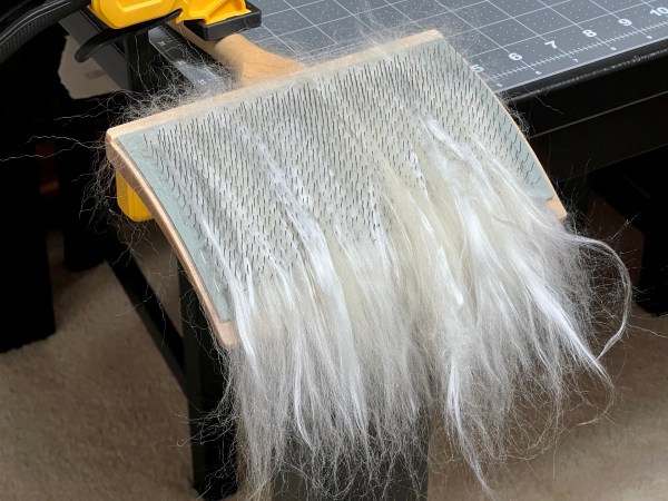 Wool and silk combed onto the hand cards once.