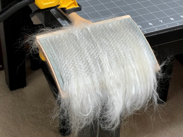 Wool and silk combed onto the hand cards twice.