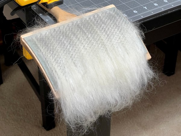 Wool and silk combed onto the hand cards three times.