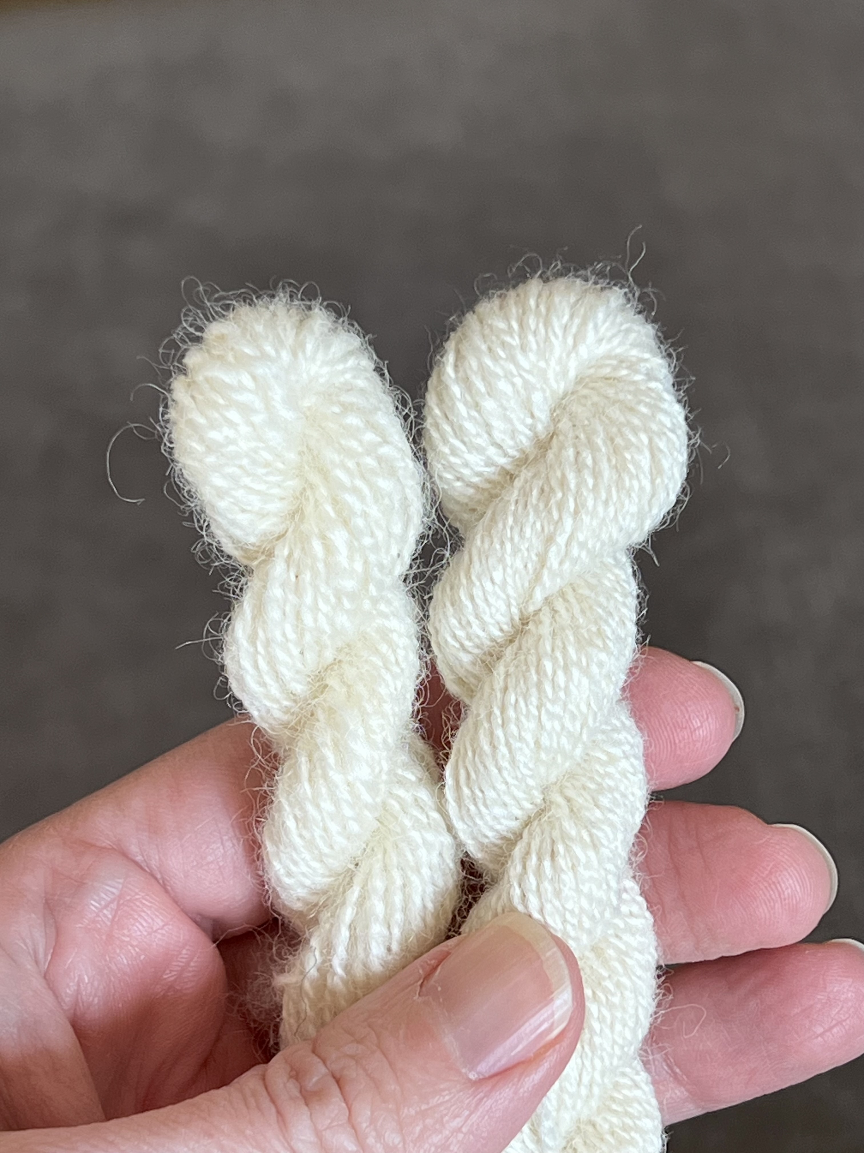 100% Romney wool with woollen prep from raw fleece (left) and 75/25% Romney-Bombyx Silk blend from a commercial-worsted prep (right) sample comparison.